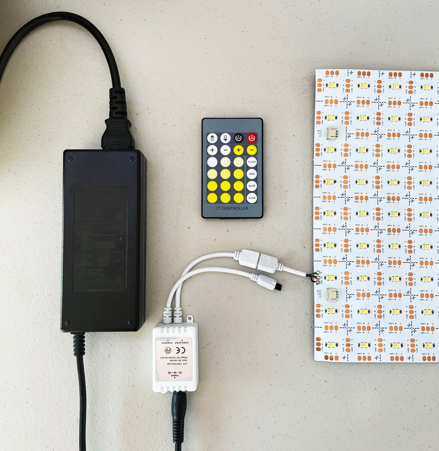 Reference image showing a CCT LED light sheet connected to a controller, remote, and power adapter